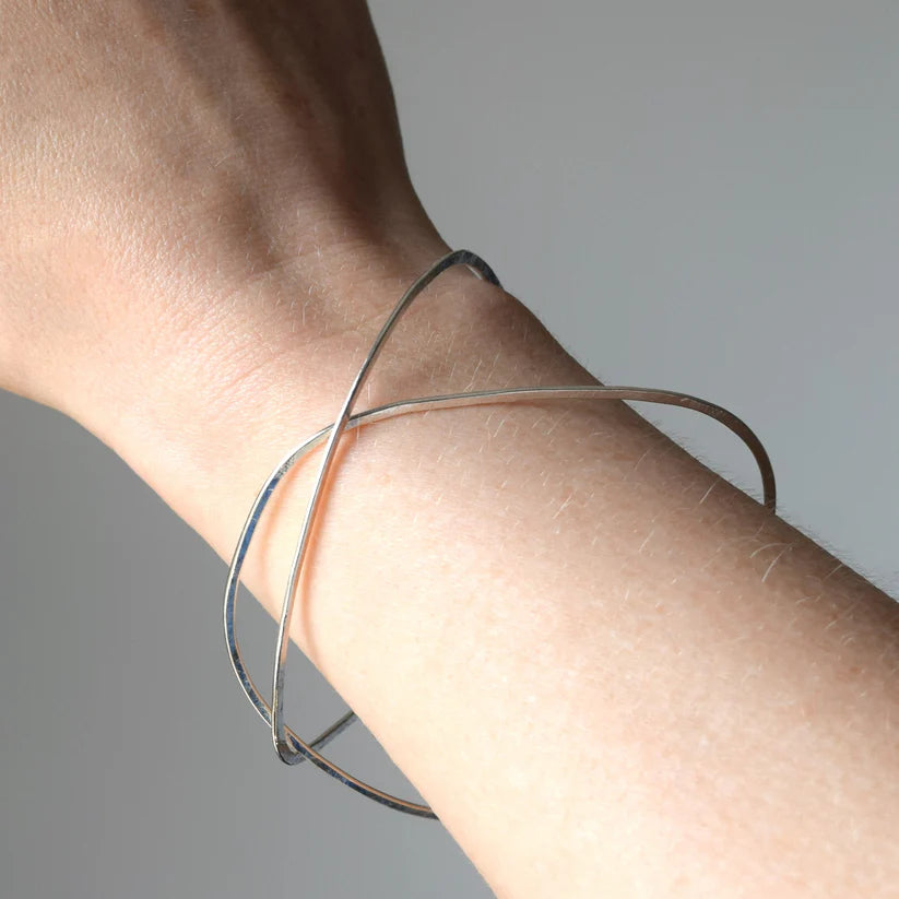 Silver crisscross bangle bracelet.  Simple, modern design.