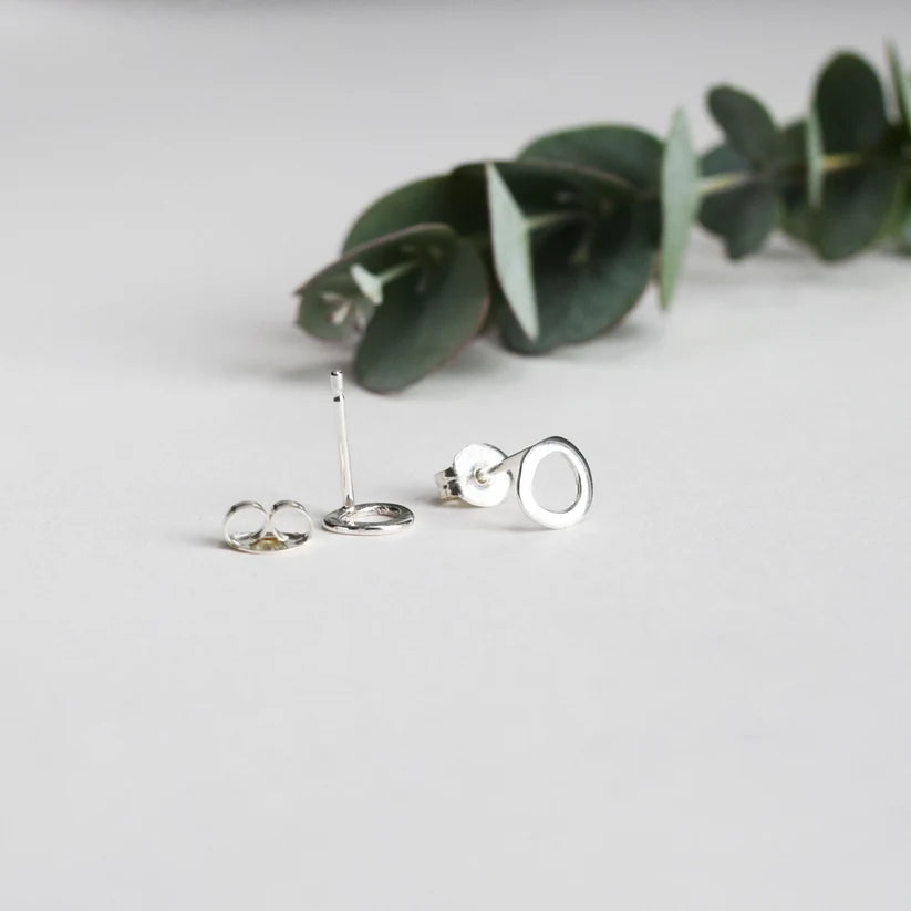 Silver circle stud earrings with textured finish.