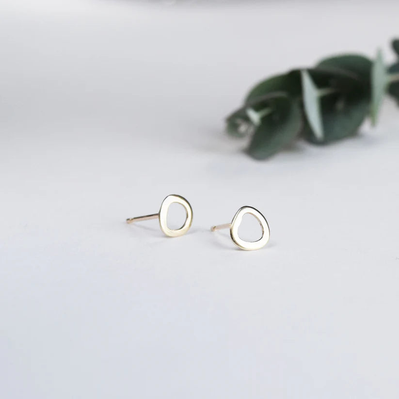 Pair of gold stud earrings; each earring features a small, irregular, open circle design.