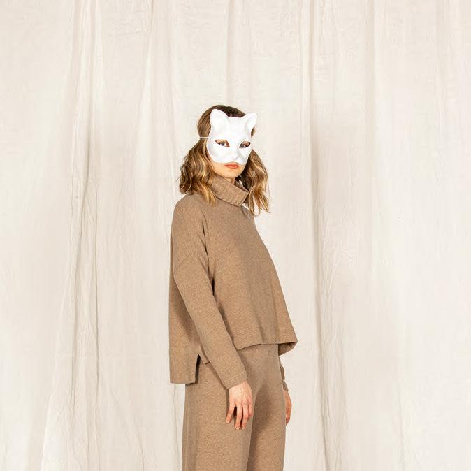 Taupe cashmere turtleneck sweater and coordinating pants.  Relaxed fit, boxy sweater with side slits.