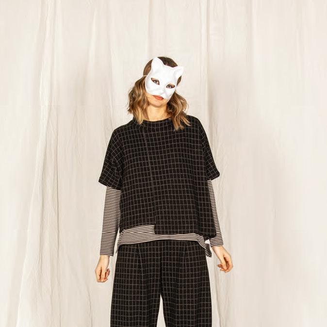 Black and white gridded women's pants and short-sleeved top set.  The top is boxy and slightly asymmetrical.