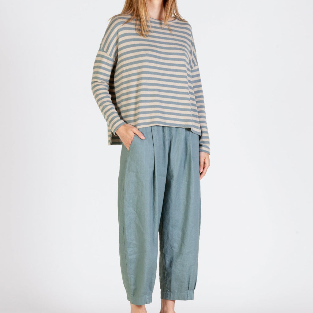 soft blue trousers with a balloon shape and narrow ankle cuff styled with Alison jumper in blue and oatmeal stripes. 