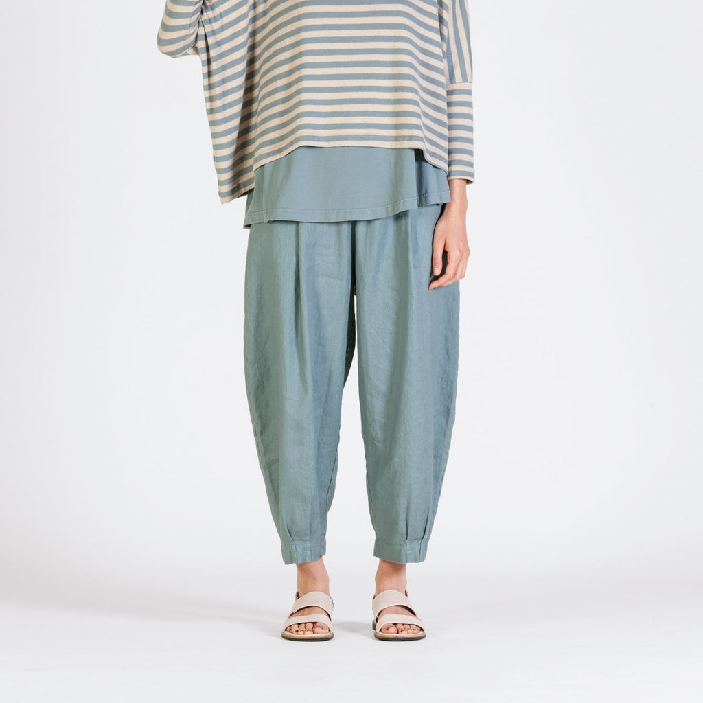 soft blue trousers with a balloon shape and narrow ankle cuff. 
