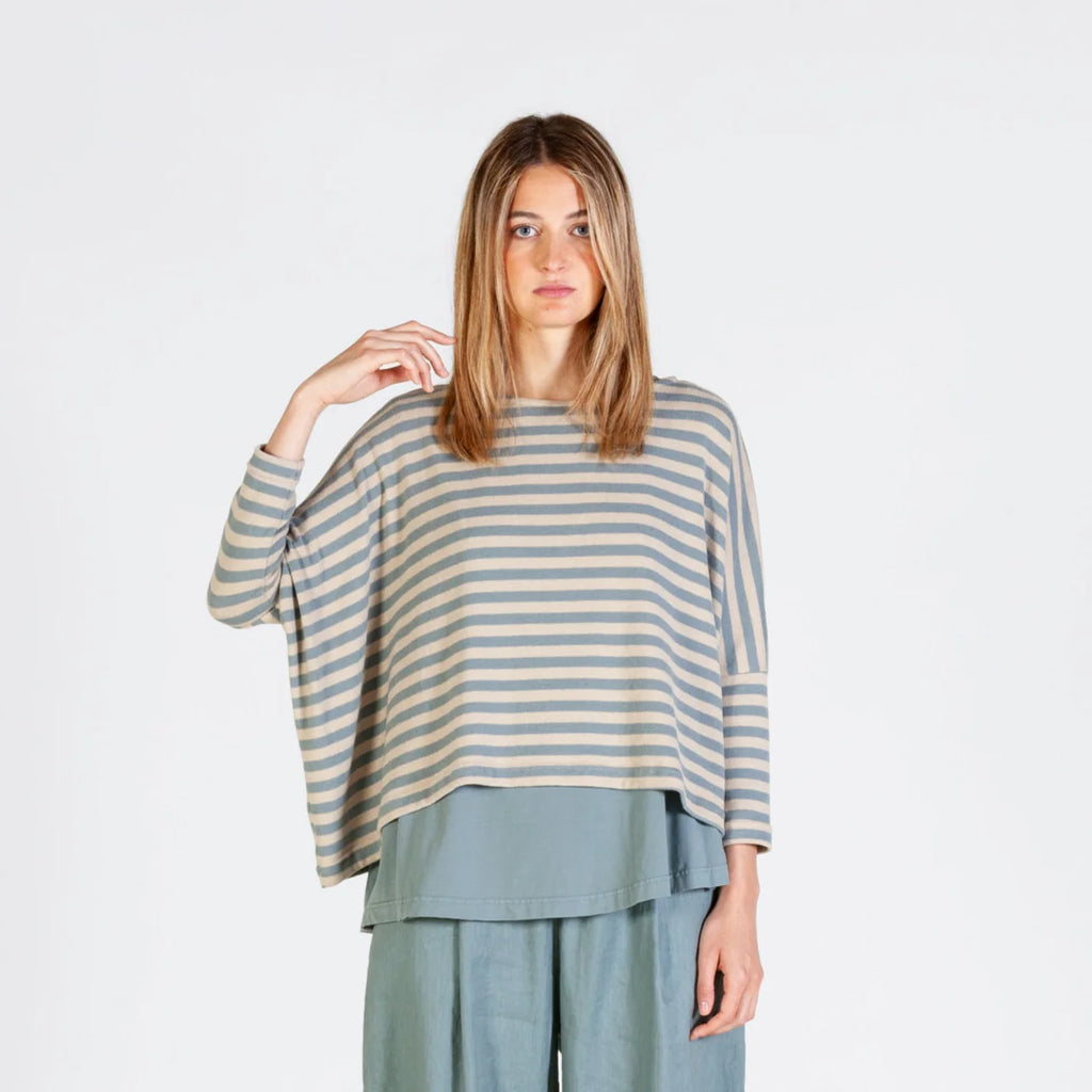 Horizontal striped, three-quarter sleeve top with a layered, longer back hem, paired with matching loose-fitting pants.