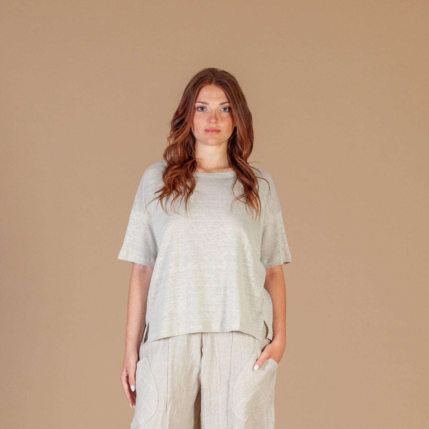 Women wearing a soft cream loose fit t-shirt