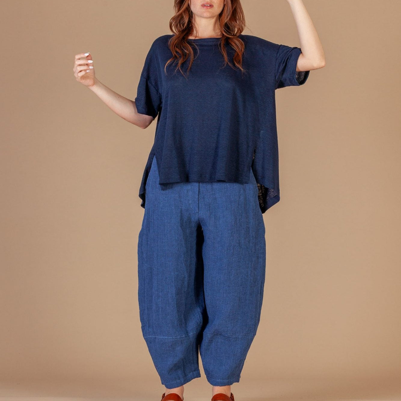 Woman wearing a blue outfit against a beige background