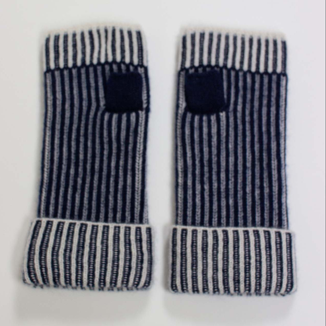 Pair of striped arm warmers on a white background