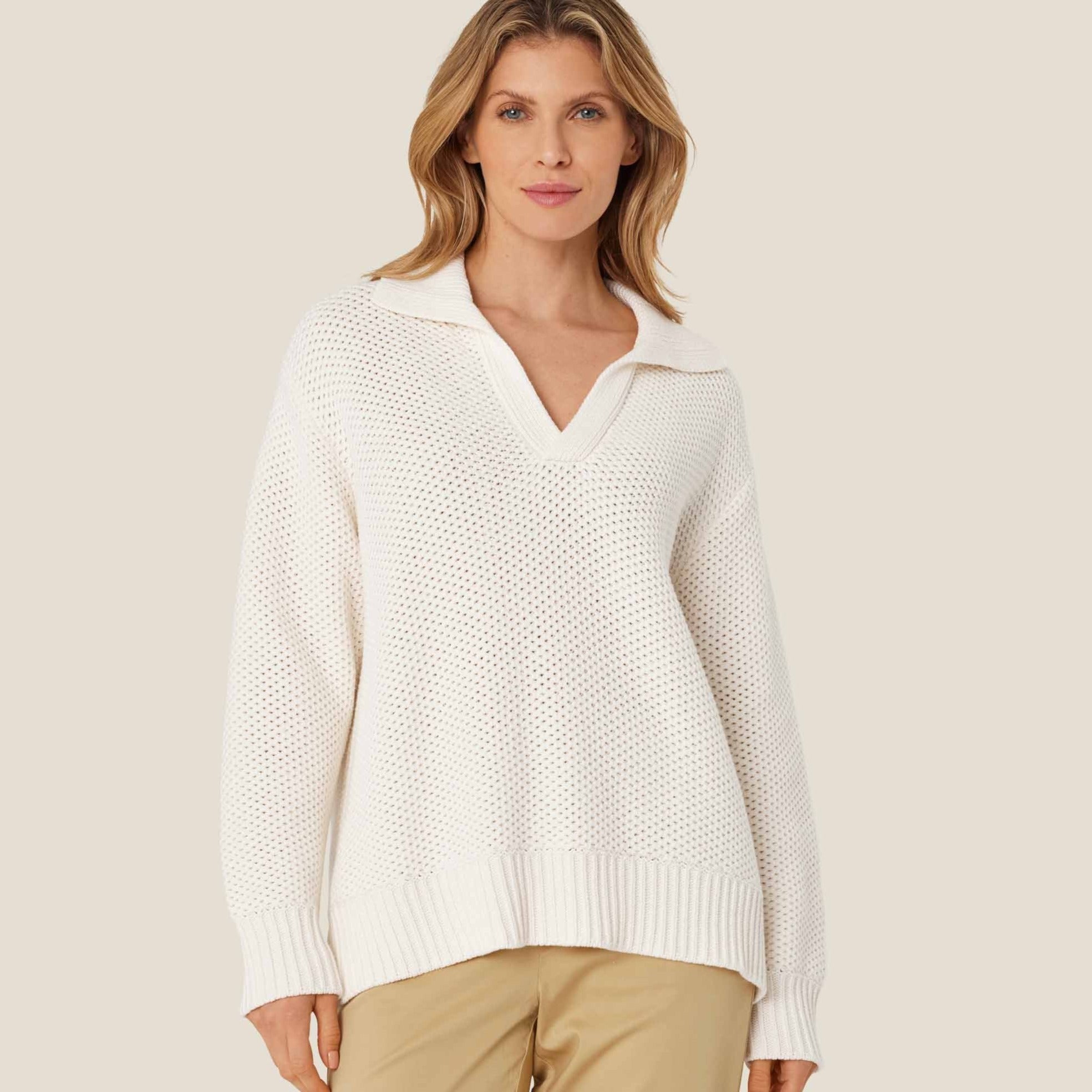 Off-white open-knit cotton sweater with a v-neck and long sleeves.