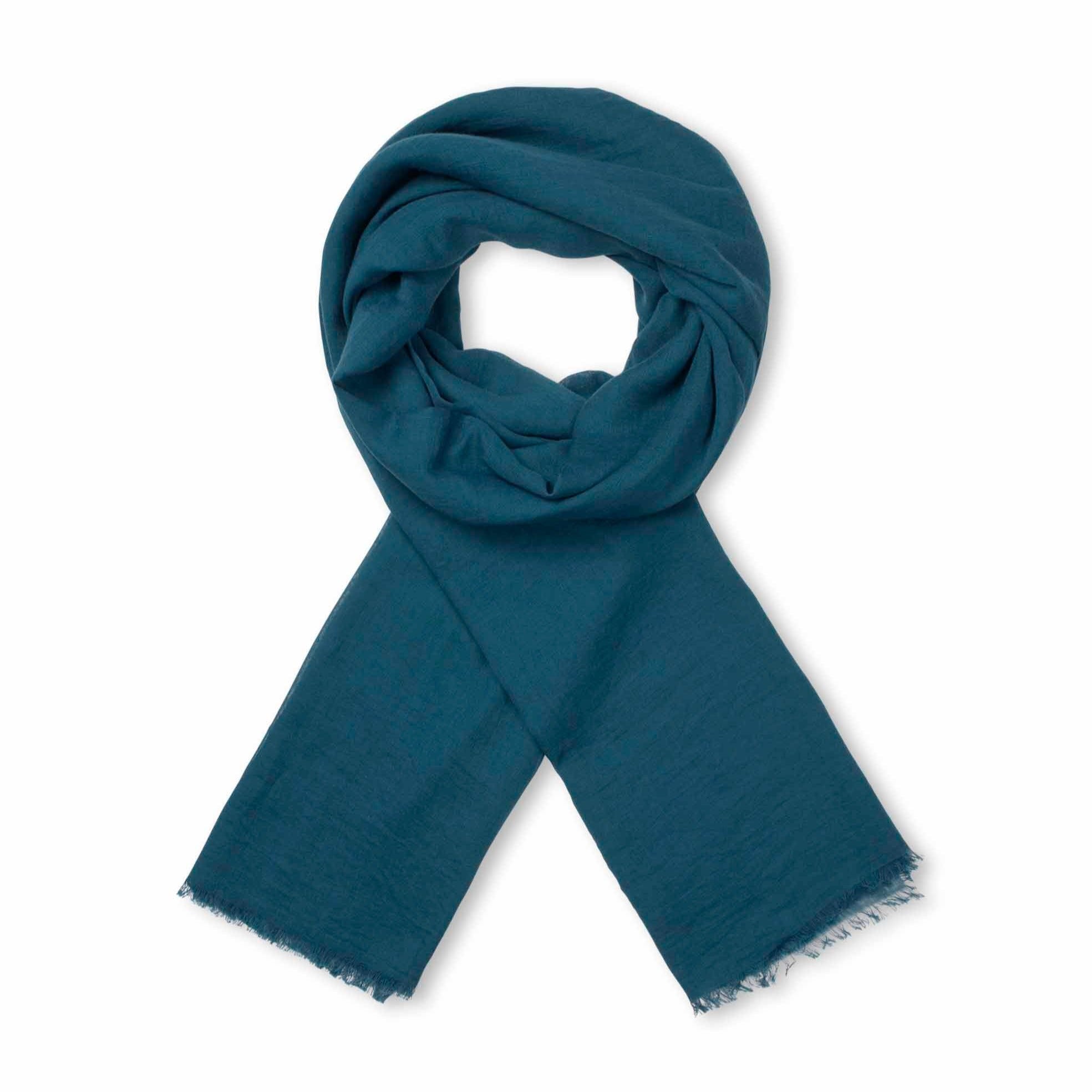Teal rectangular scarf, loosely folded, with frayed edges.