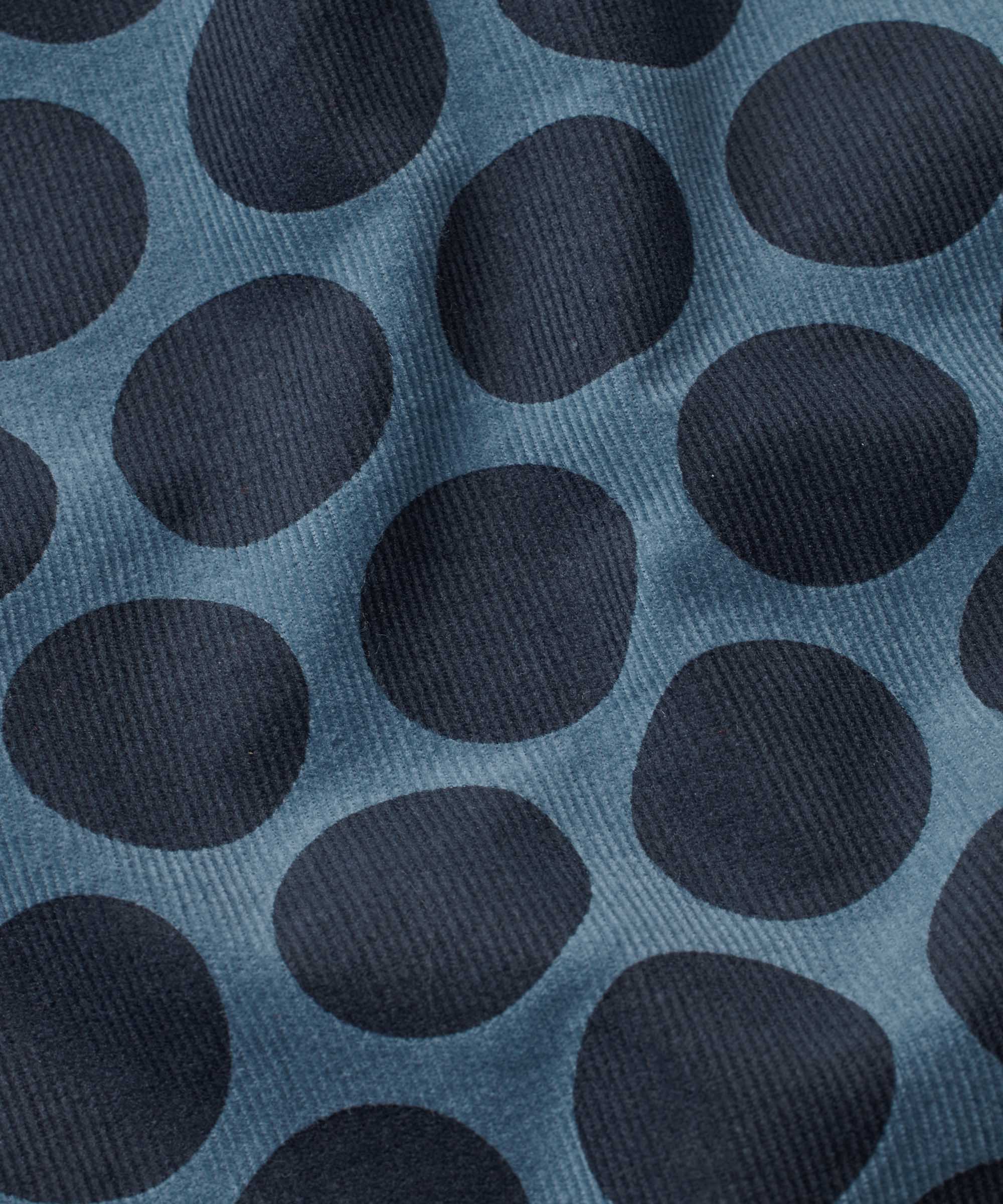 Pattern of dark blue circles on a textured blue background