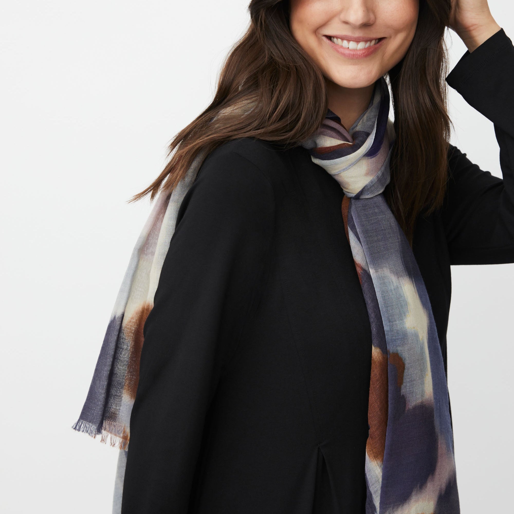 Woman wearing a patterned scarf on a white background