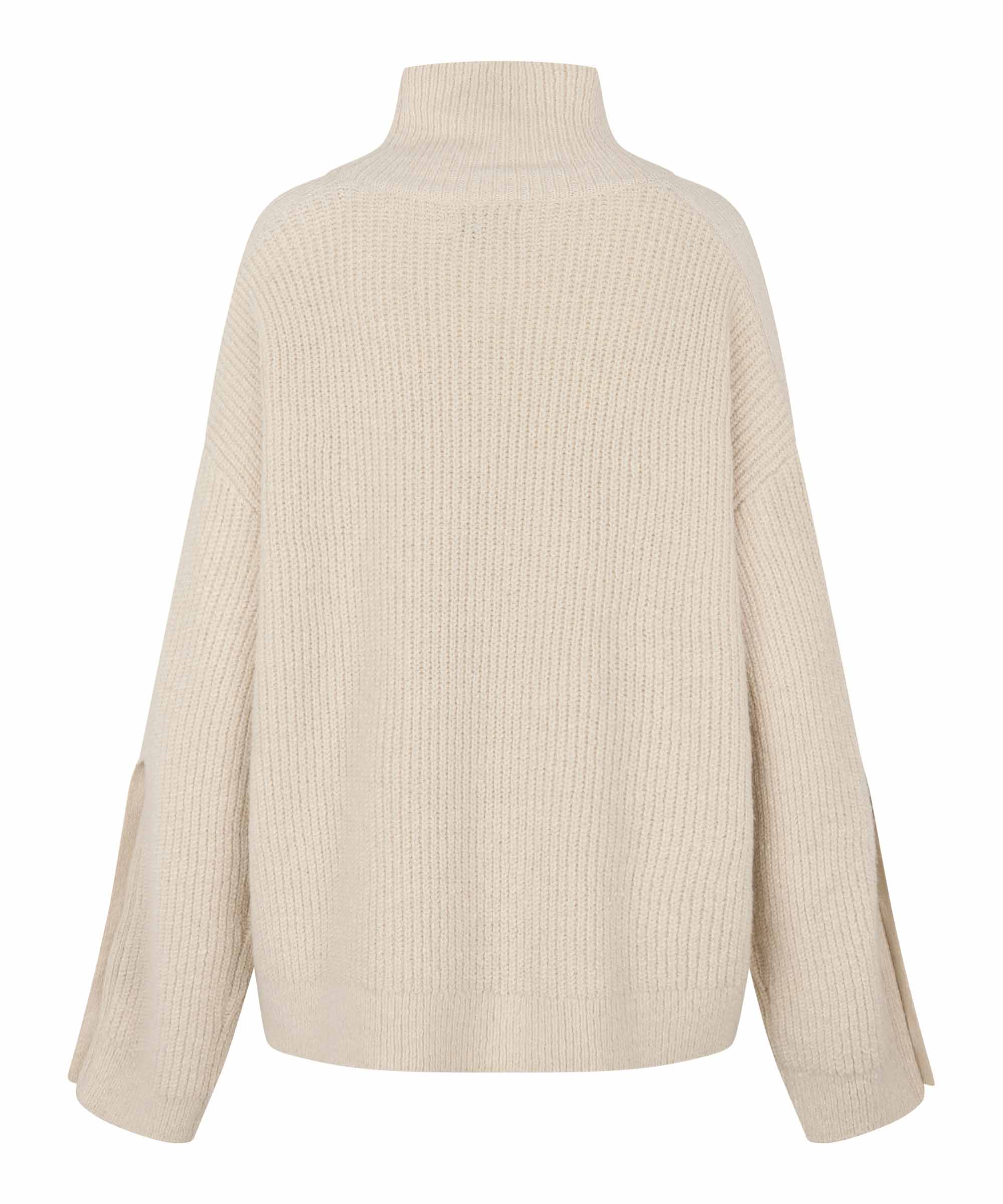 A cream-colored ribbed knit turtleneck sweater shown from the back, featuring long sleeves with side slits, set against a plain white background.