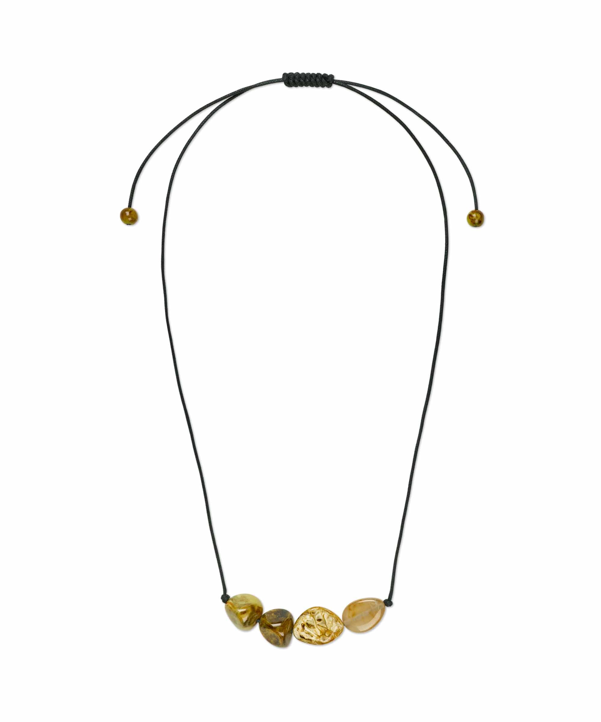 Necklace with gold beads on a black cord against a white background
