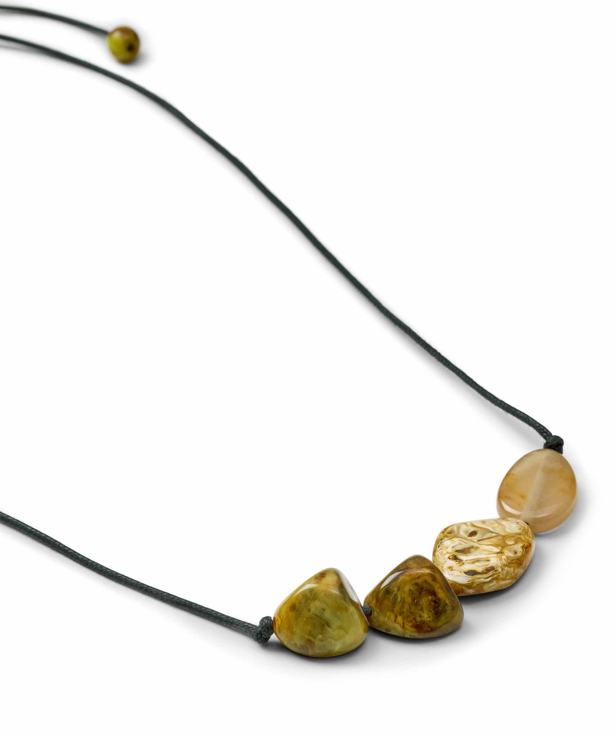 A black cord necklace featuring four polished, organic-shaped stones in shades of olive green, yellow, and beige, displayed on a clean white background.