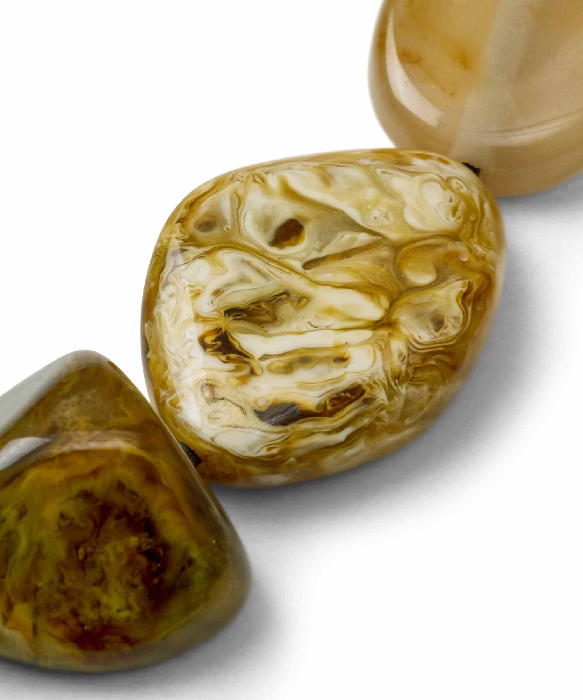 Two polished stones with marbled patterns on a white background