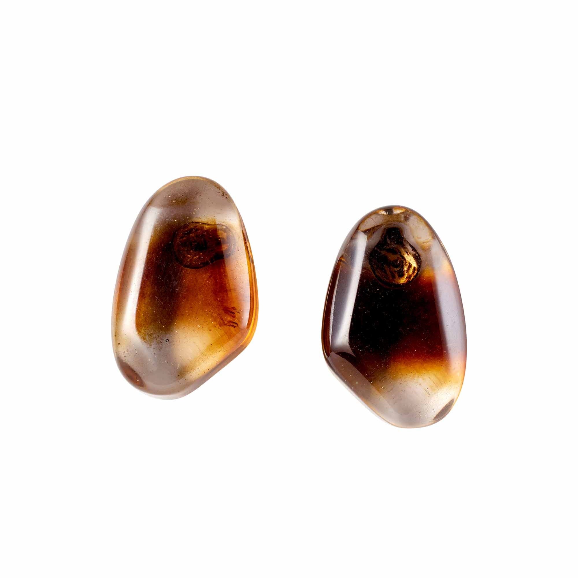Pair of amber-colored earrings on a white background