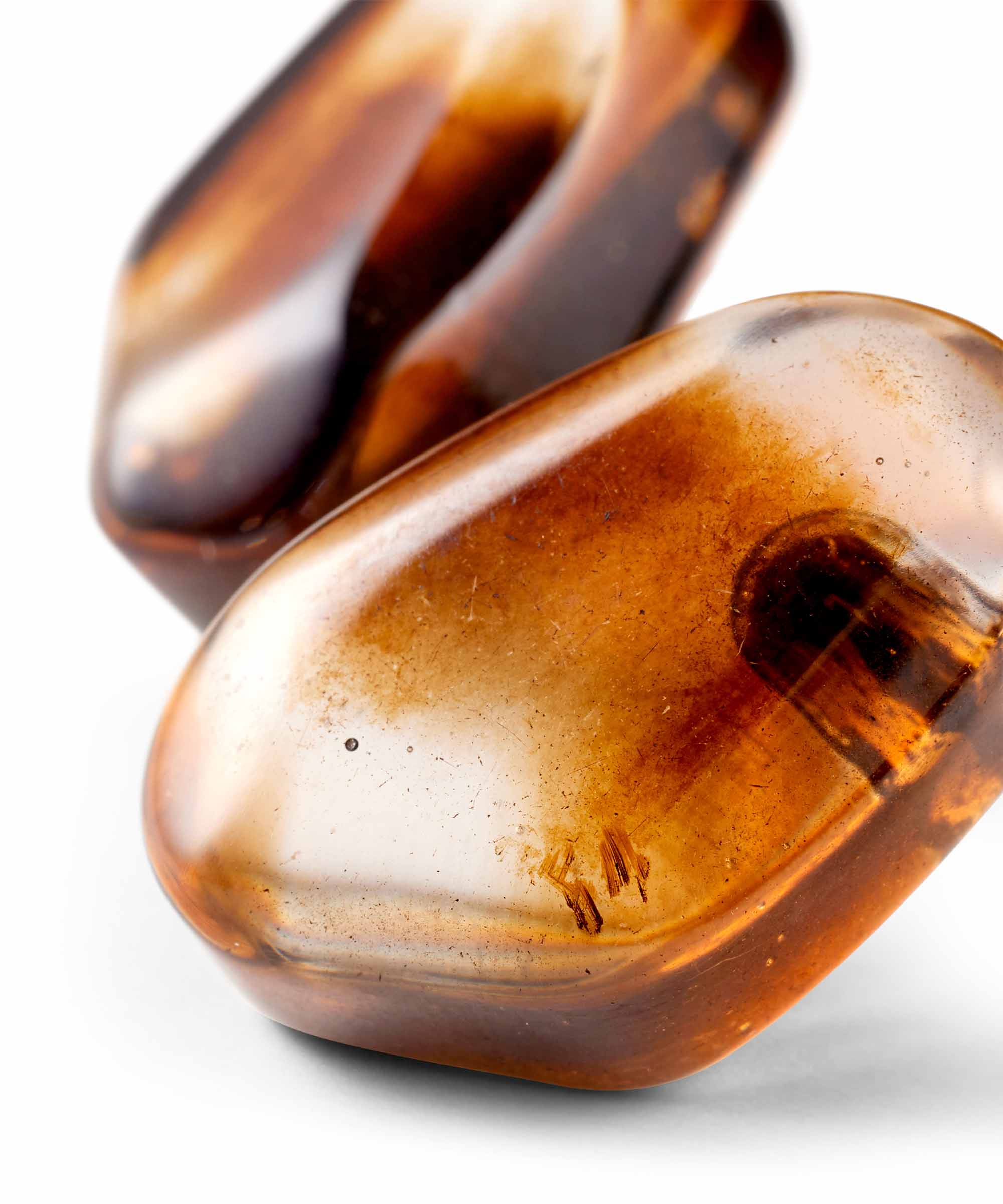 Close-up of two brown stones on a white background