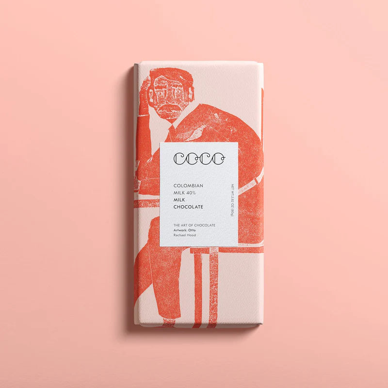 Coco Colombian 40% milk chocolate bar, featuring red illustration of seated man on off-white wrapper.