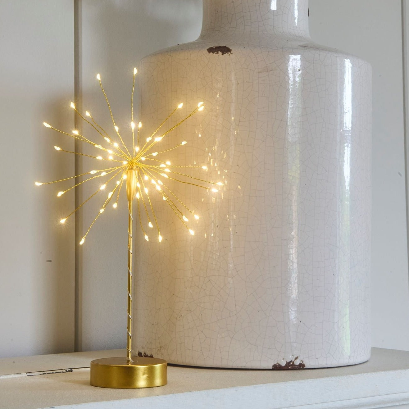 Gold metal tabletop firework light with illuminated LED tips.