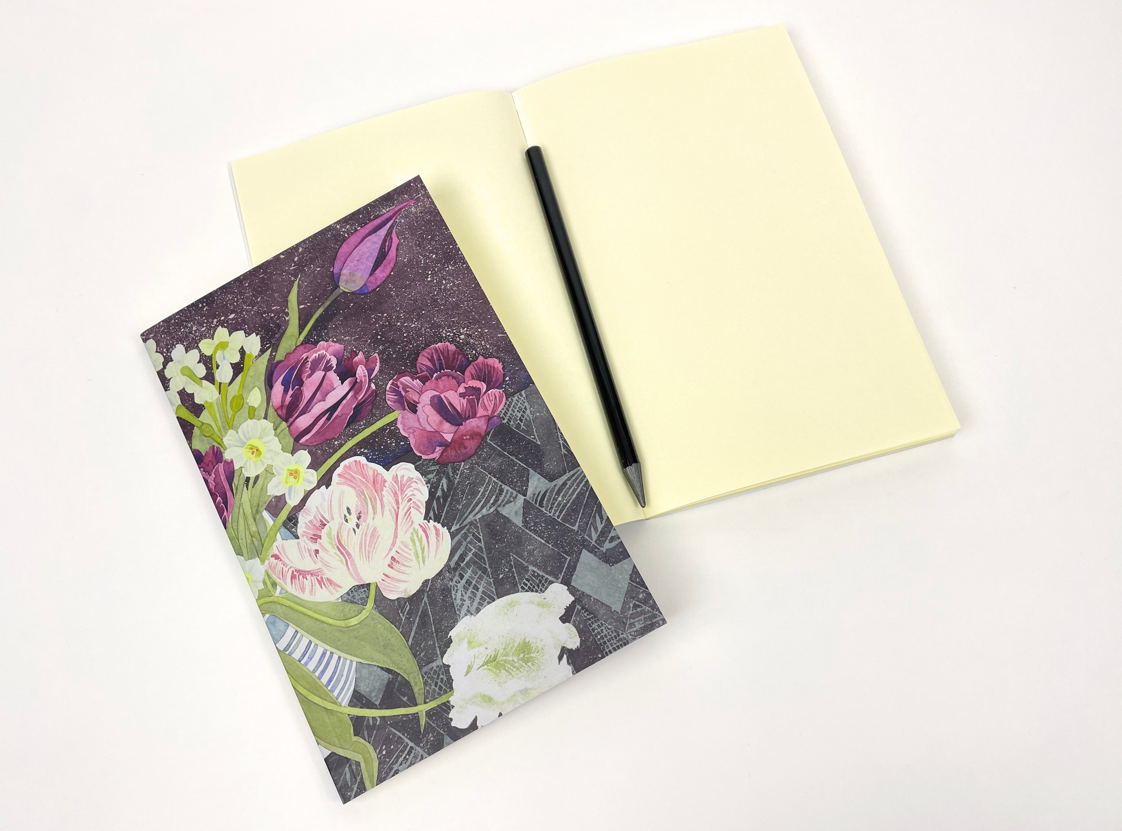 Floral notebook with pale yellow blank notebook and pencil.