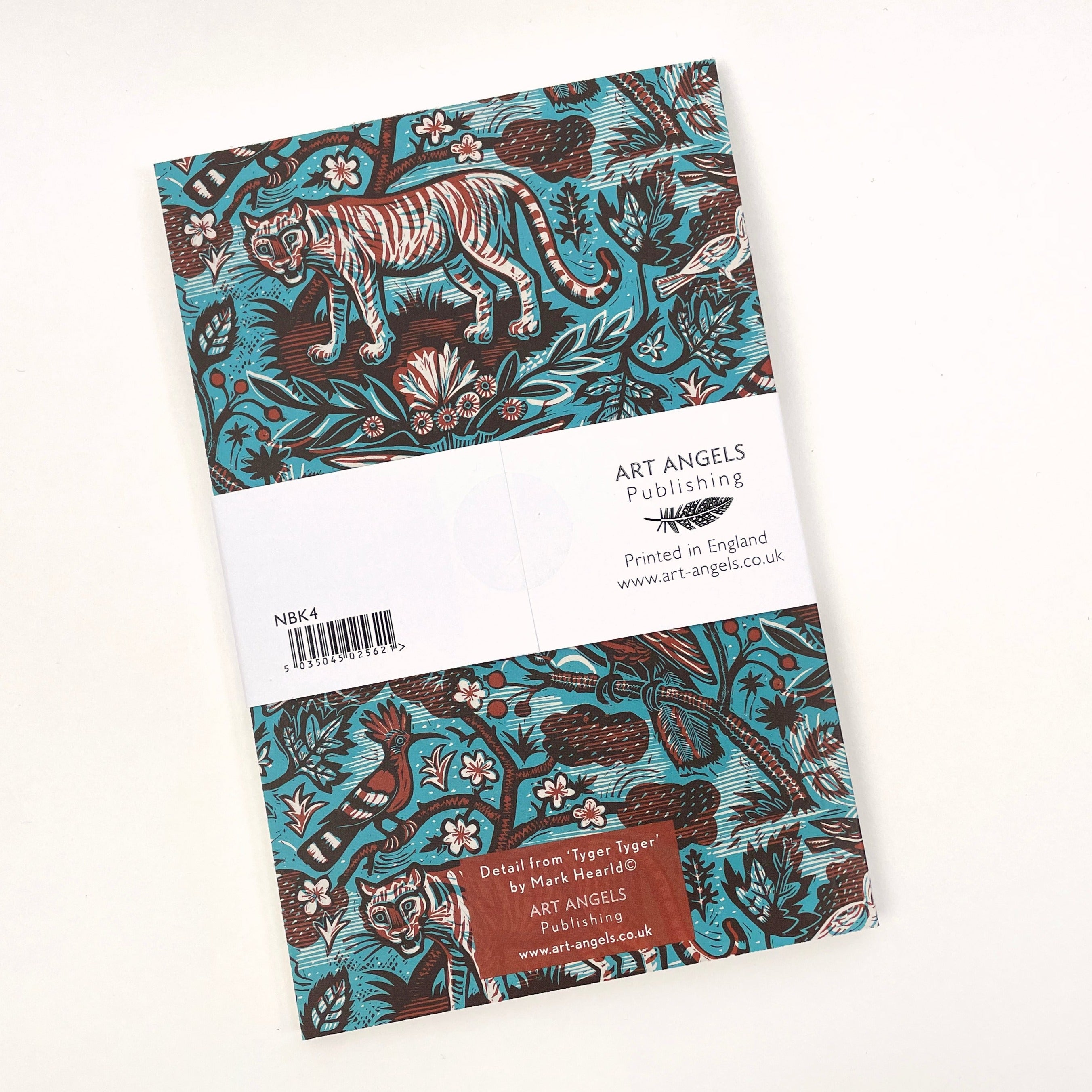 Notebook with teal cover featuring a woodblock print design of tigers, birds, and floral elements in brown and white.