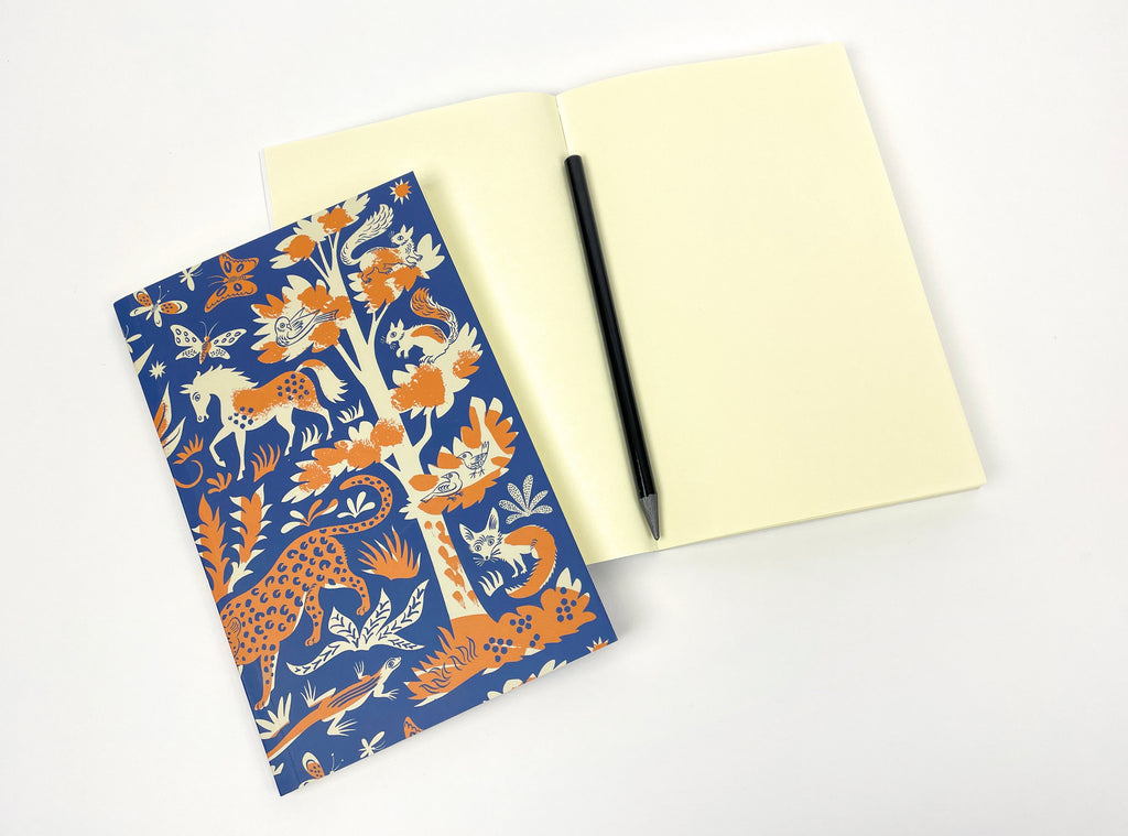 Notebook with a blue cover featuring an orange and cream animal and nature pattern.