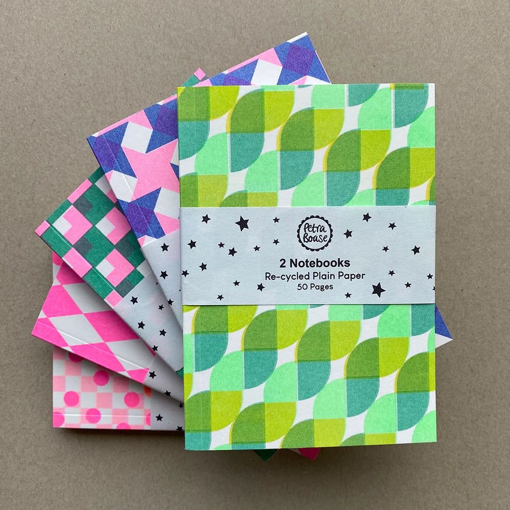 Set of two notebooks with 50 pages each, featuring vibrant geometric designs on recycled paper.