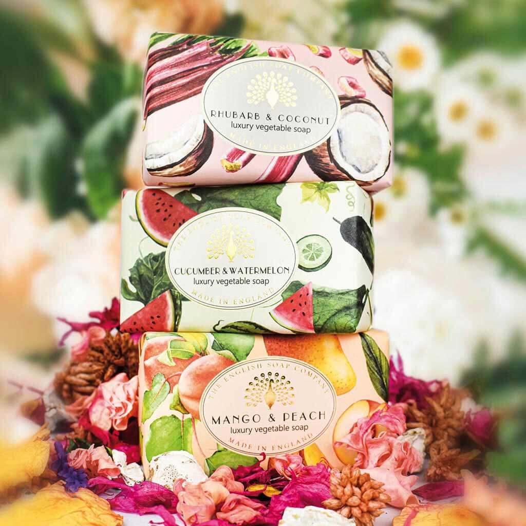 Stack of three luxury vegetable soaps: rhubarb & coconut, cucumber & watermelon, and mango & peach.