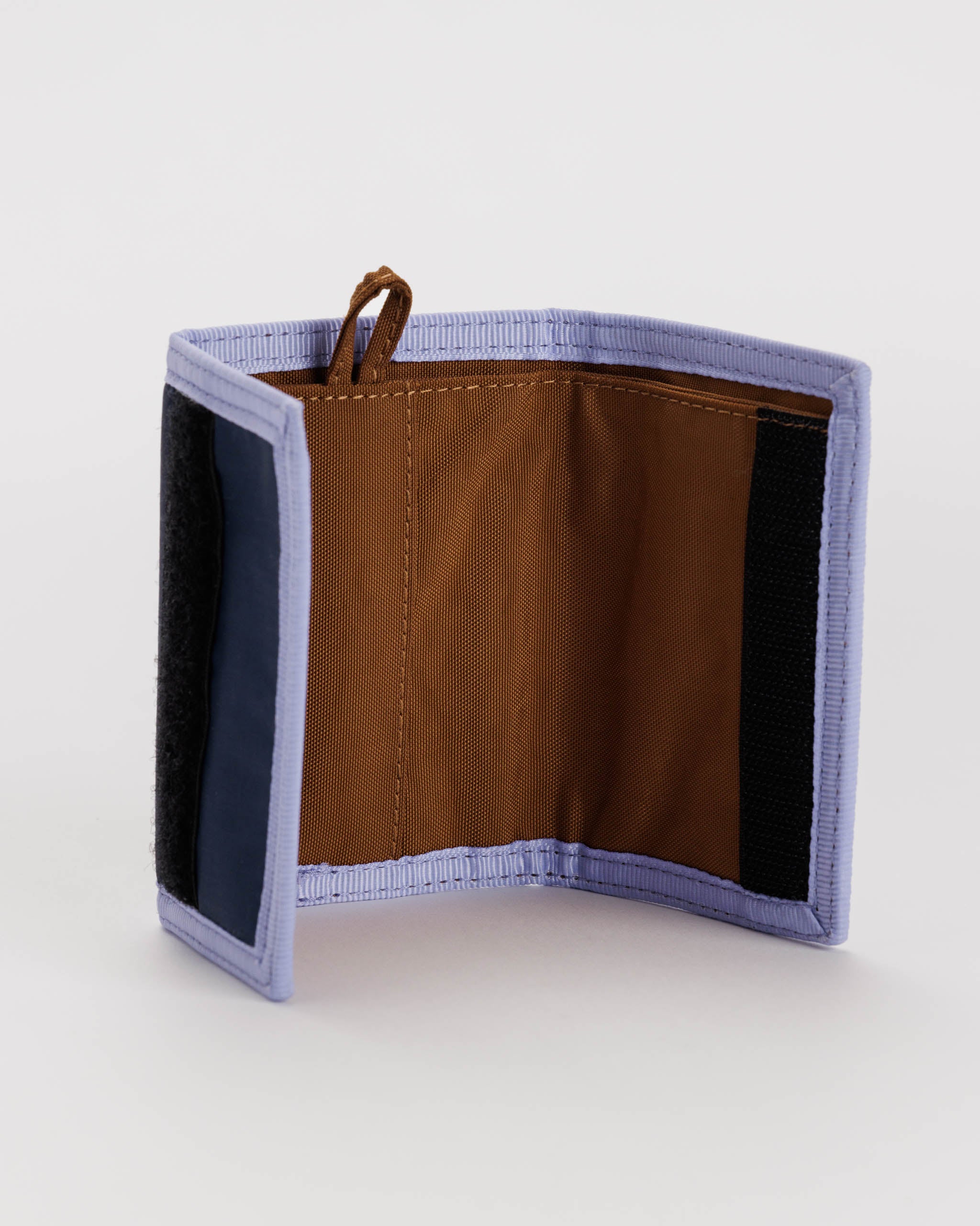 Brown and lavender tri-fold wallet open to reveal interior pockets and card slots.