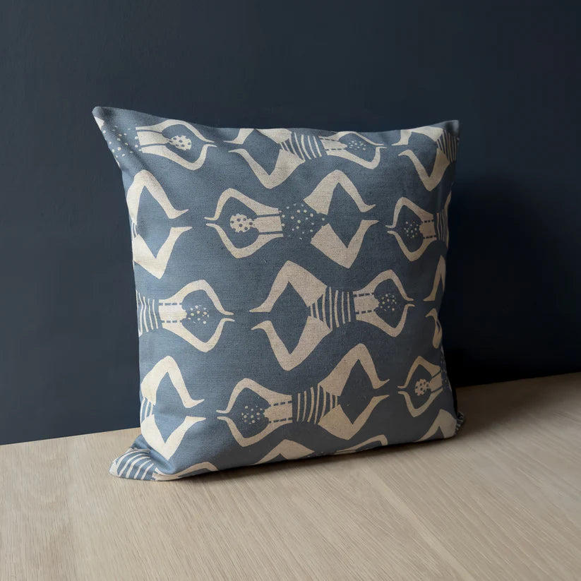 Grey square cushion with a repeating pattern of stylized figures in off-white, reminiscent of swimmers.