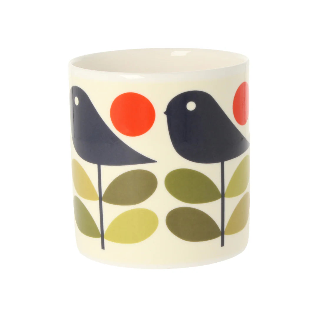 Ceramic mug with bird and leaf design on a white background