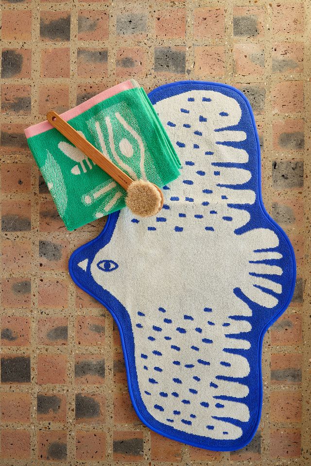 Decorative rug with abstract design on a textured wall background