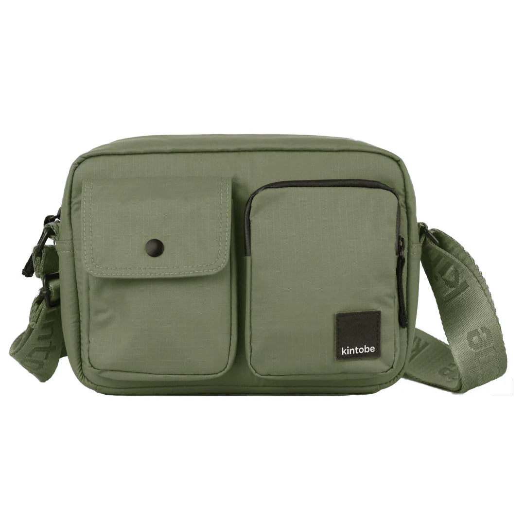Olive green crossbody bag with two front pockets and adjustable strap.  Features a small rectangular logo patch.
