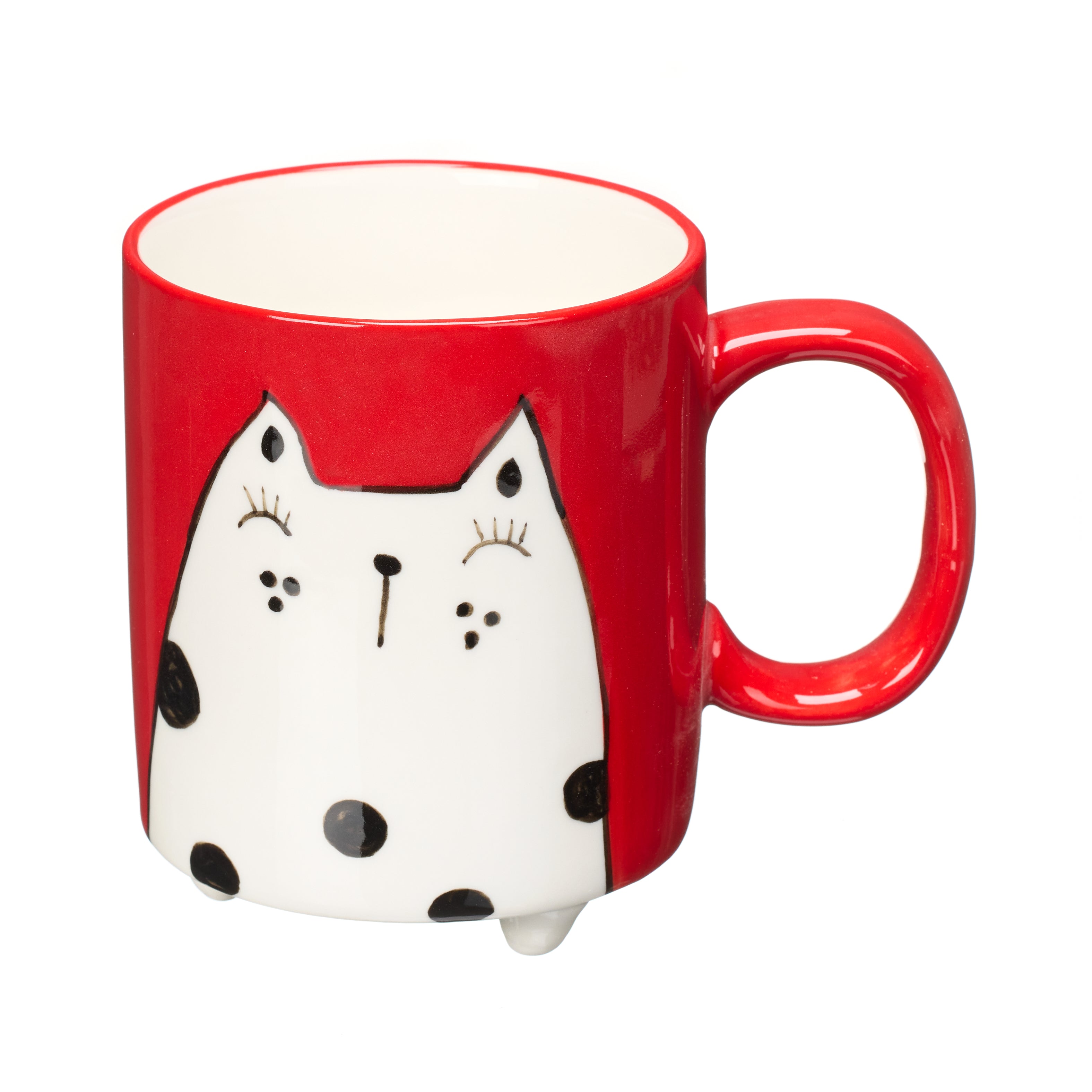 Red mug with a whimsical black and white cat design, featuring black polka dots and small feet.