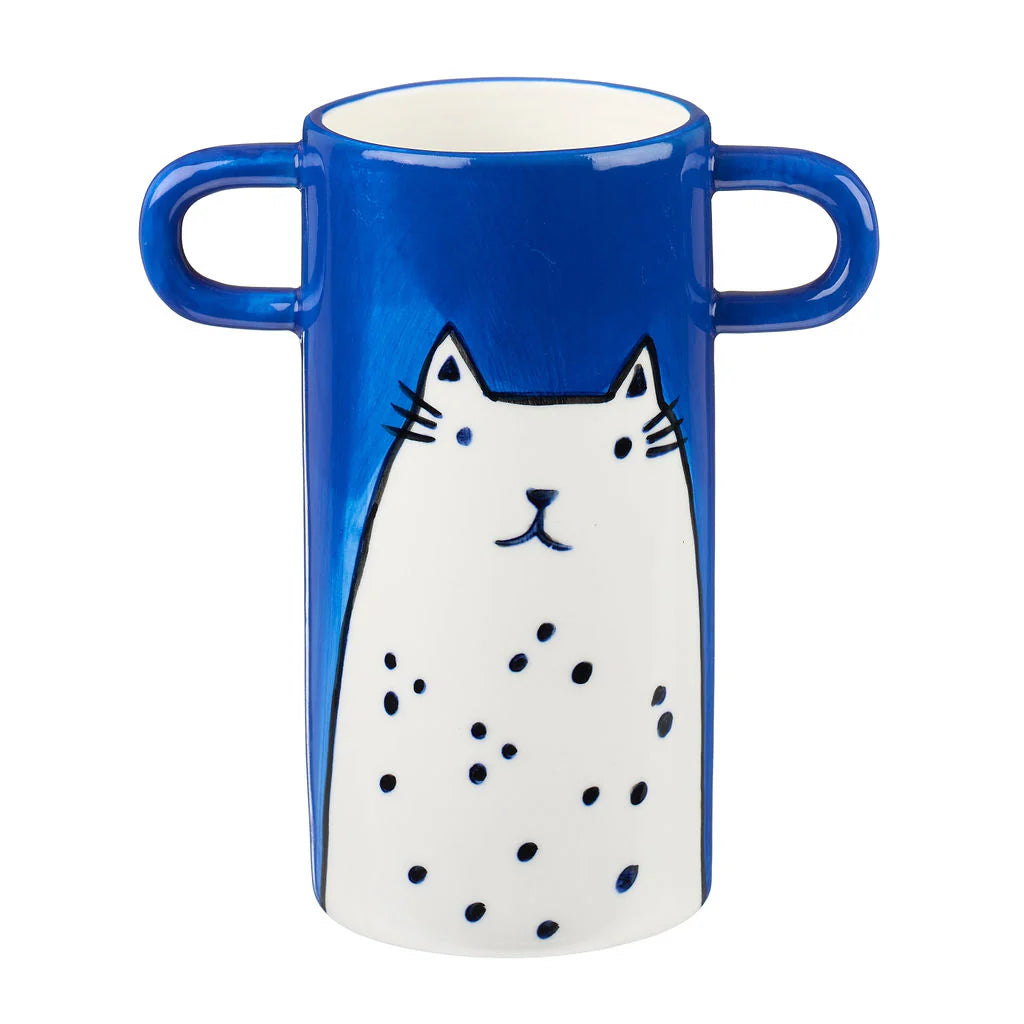 Blue ceramic mug with two handles, featuring a hand-drawn white cat with black dots.
