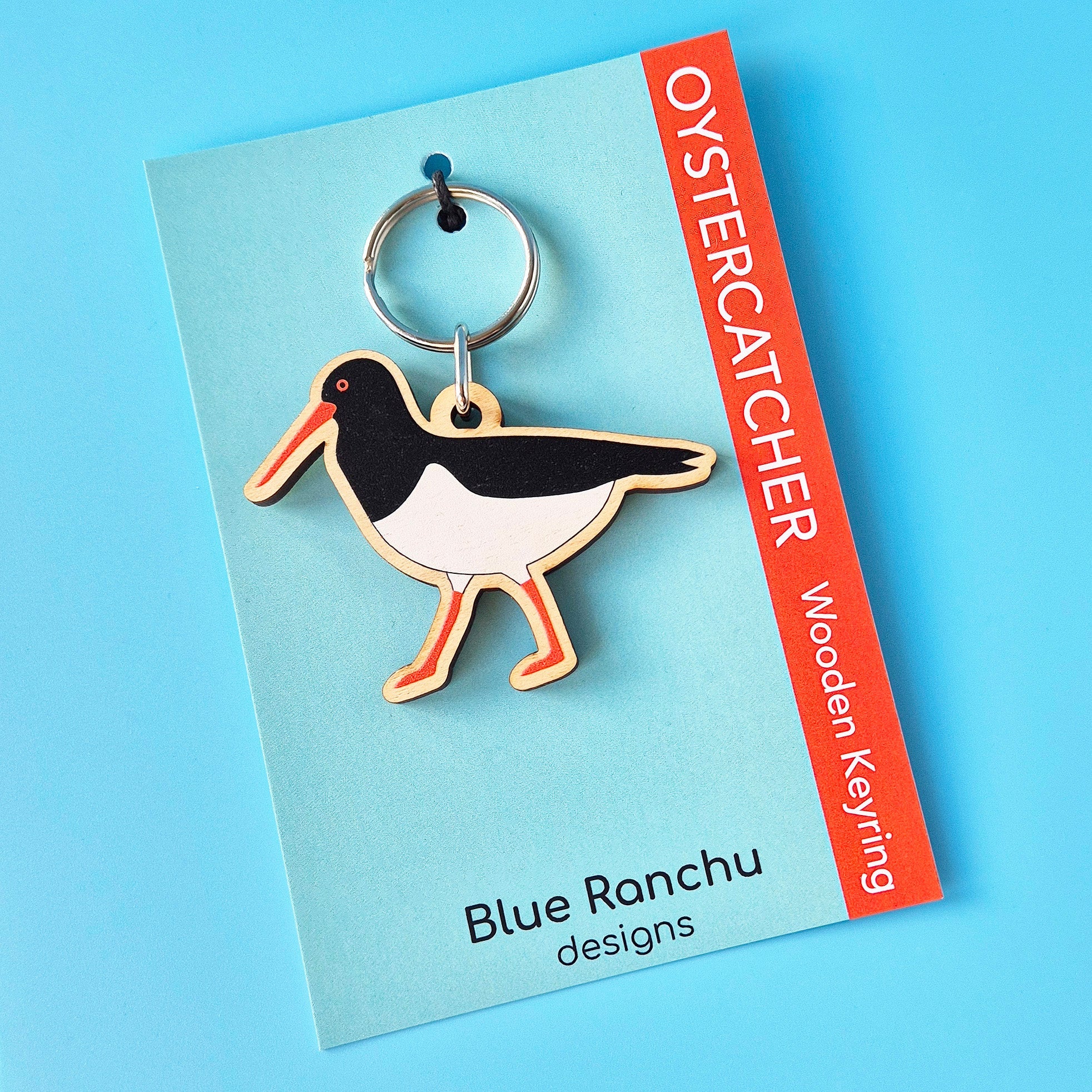 Oystercatcher wooden keyring on a Blue Ranchu designs card against a blue background