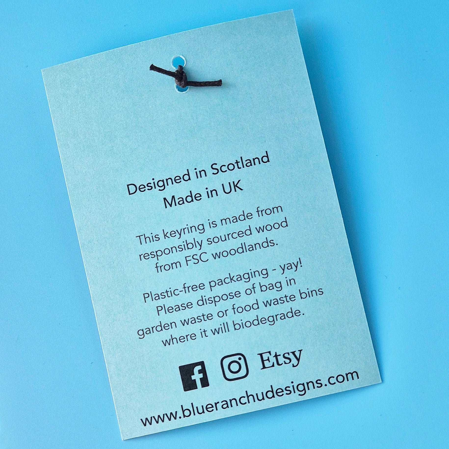 Product label on a blue background with text about design location, material sourcing, and Etsy branding.