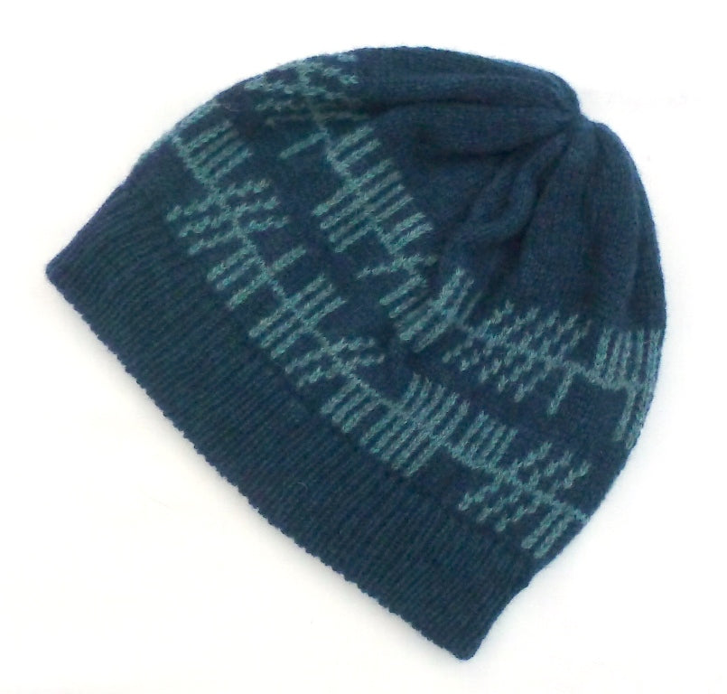 Blue knitted beanie with a pattern on a white background