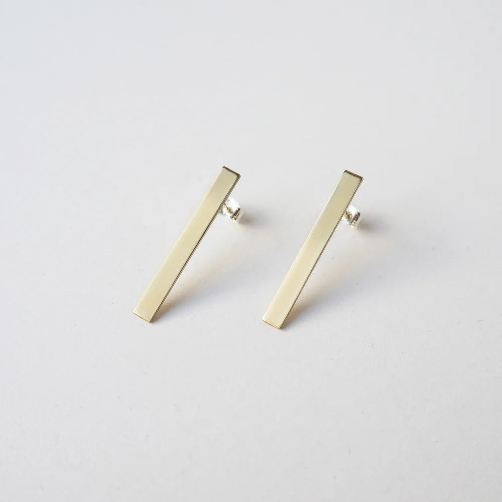 Pair of gold bar stud earrings; angled rectangular design.