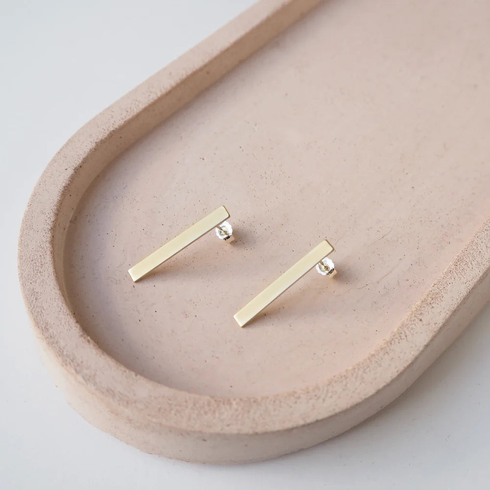 Pair of gold bar stud earrings.