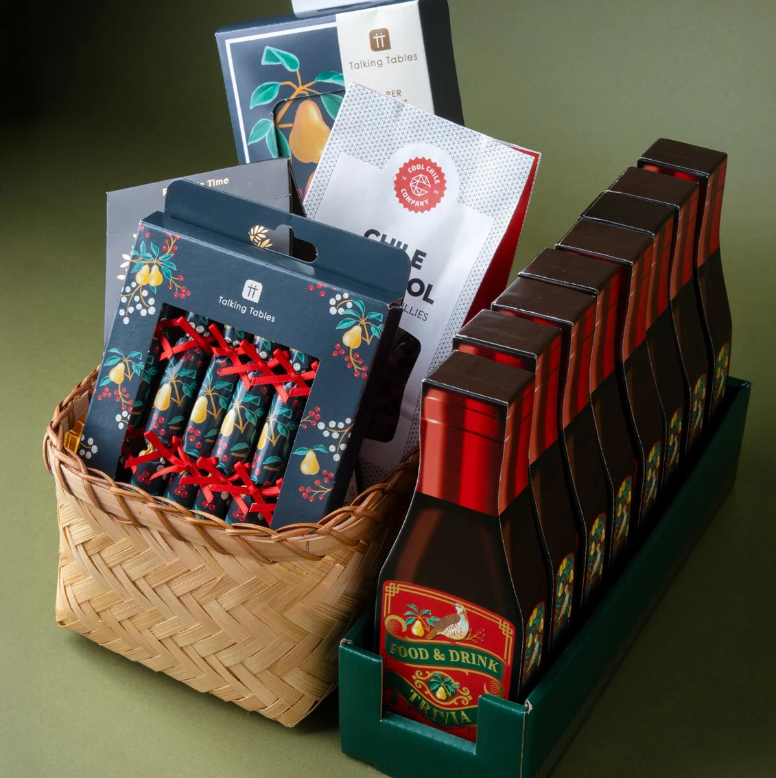 Basket with various tea packages and boxes on a green background