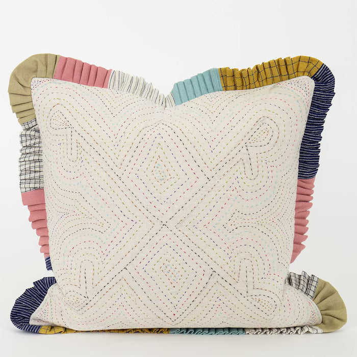 Quilted pillow with colorful patchwork border on a white background