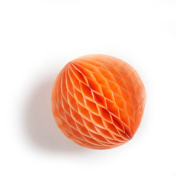 Orange honeycomb paper ball decoration.