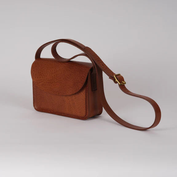 Brown leather crossbody bag with a flap closure and textured surface.