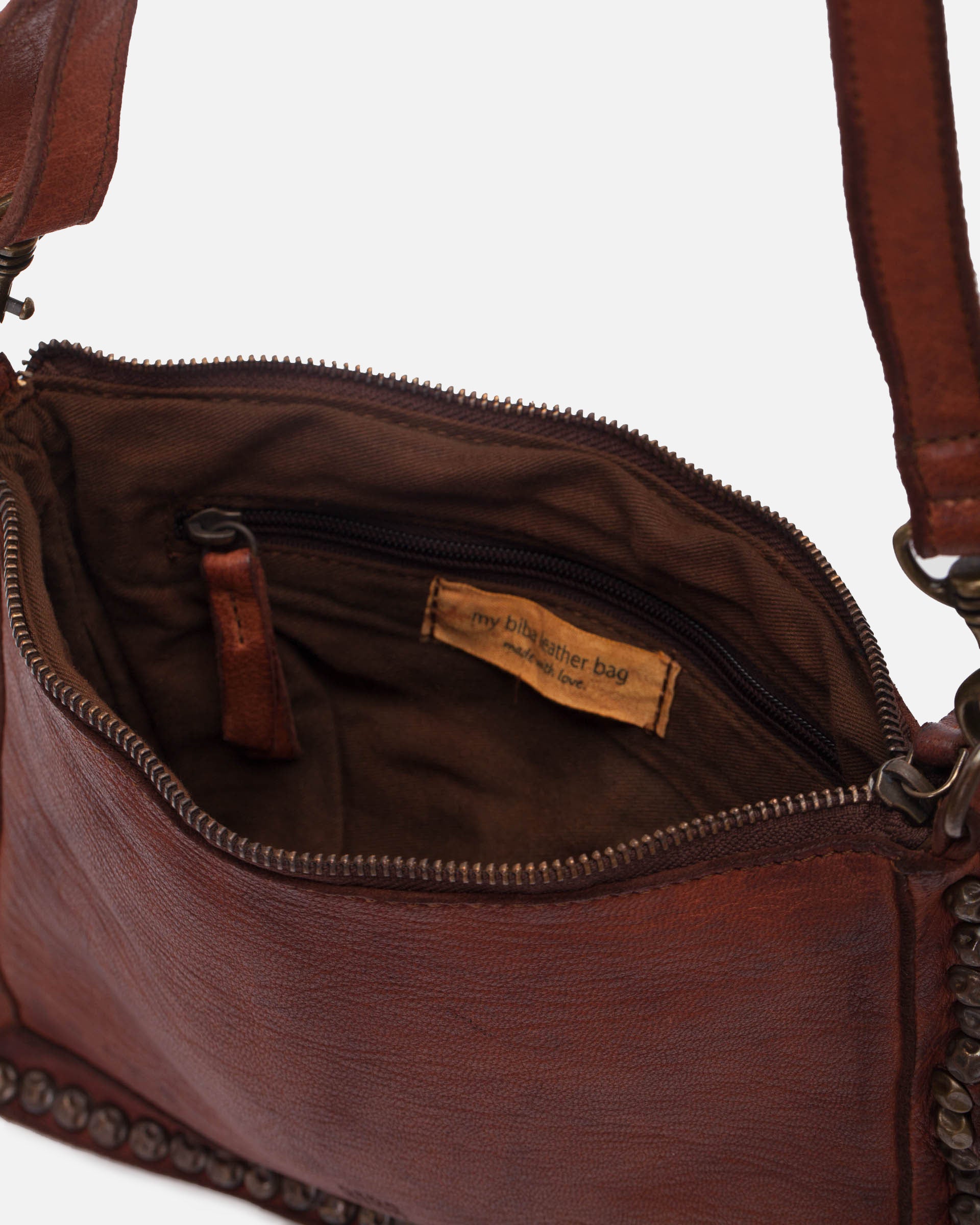 Brown leather handbag with visible brand tag on a white background