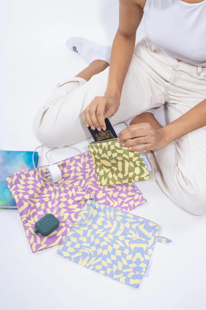 Three patterned zipper pouches in lavender, olive, and light blue.  Each pouch features an abstract swirling design.