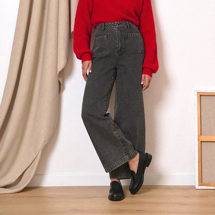 Dark gray wide-leg jeans with patch pockets, shown worn with black loafers.