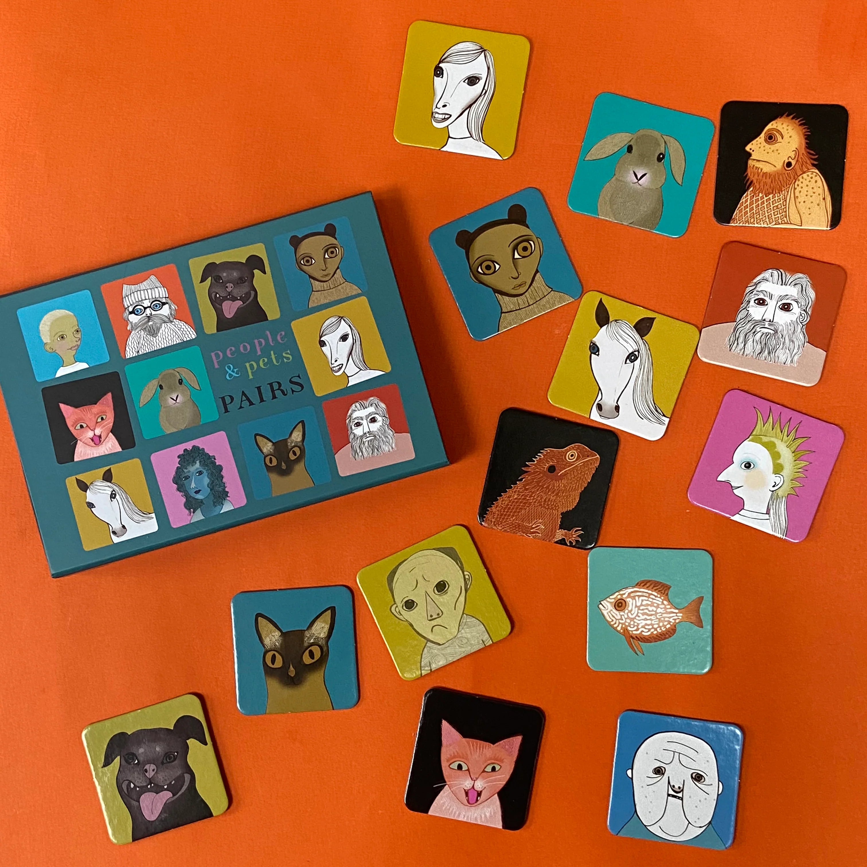 Board game 'People & Pets Pairs' with character cards on an orange background