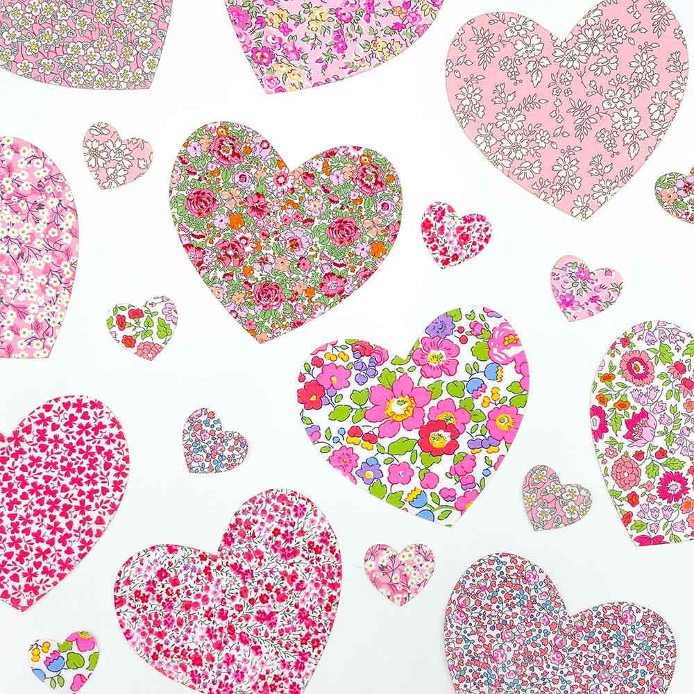 Collection of floral Liberty print hearts in various sizes and patterns on a white background.