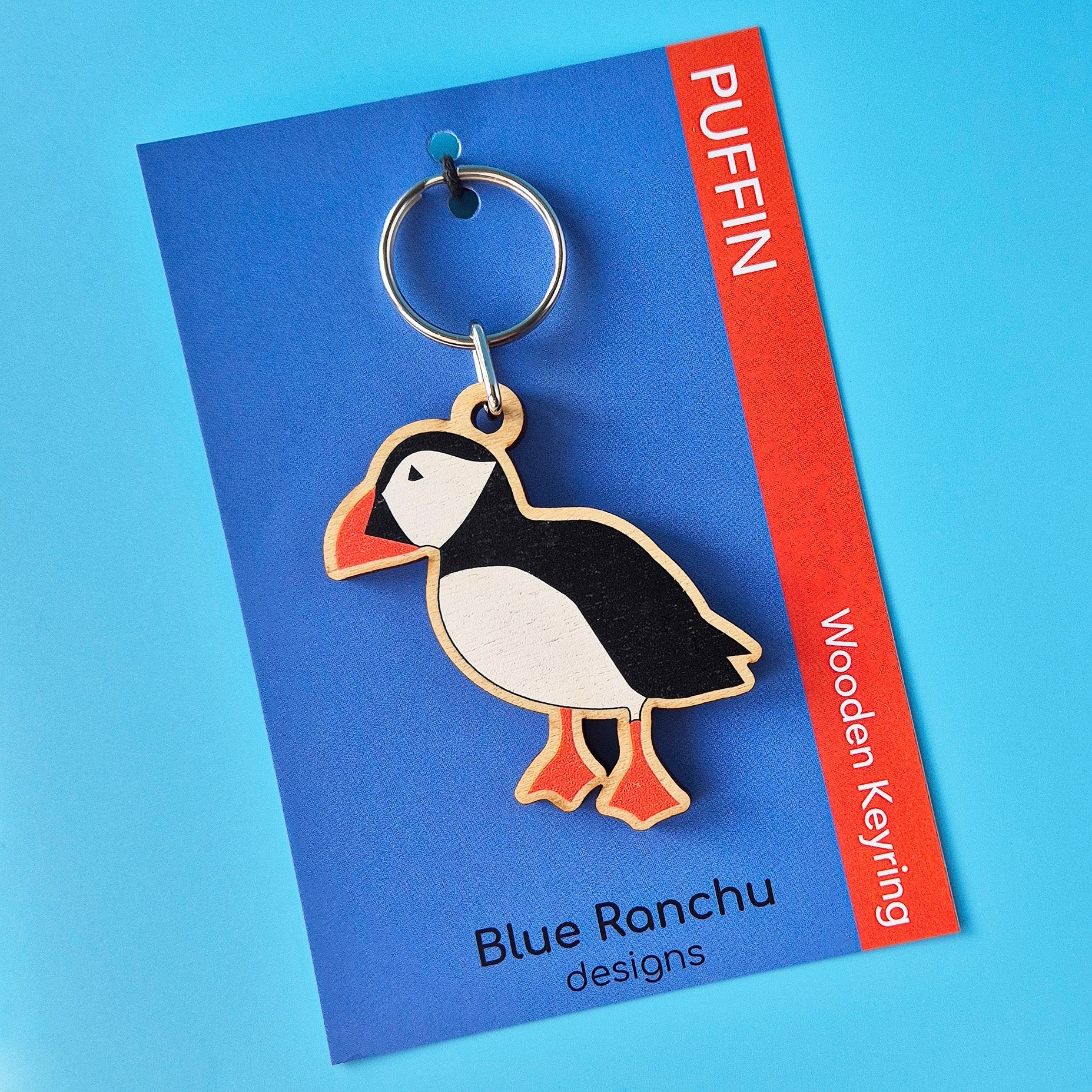 Puffin-shaped keyring on a Blue Ranchu designs card with a blue background